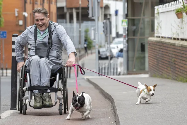 Larry O’Reilly pictured with his dogs, “Dotsy” a French Bulldog and “Tiny” a Jack Russell Terrier on Bride Street in Dublin on May 21, 2023. (Photo by Tom Honan/The Irish Times)