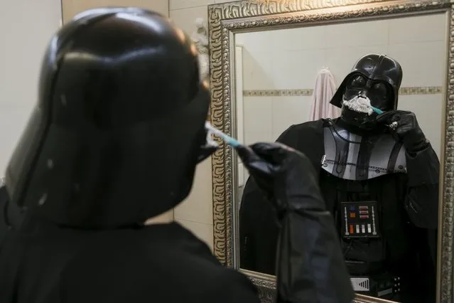 Darth Mykolaiovych Vader, who is dressed as the 'Star Wars' character Darth Vader, poses for a picture as he pretends to clean his teeth in the bathroom of his apartments in Odessa, December 2, 2015. (Photo by Valentyn Ogirenko/Reuters)