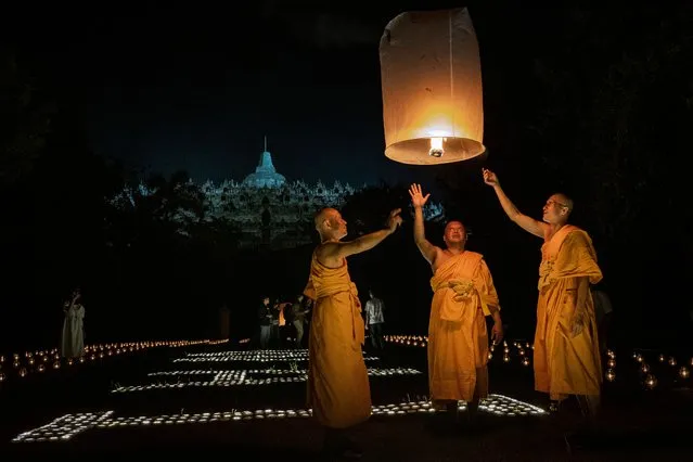 Buddhist monks release a lantern into the air on Borobudur temple during celebrations for Vesak Day on June 4, 2023 in Magelang, Central Java, Indonesia. (Photo by Ulet Ifansasti/Getty Images)
