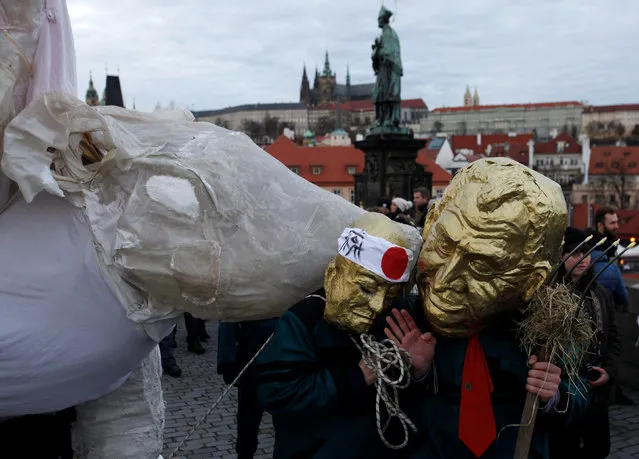 People wearing masks march across the medieval Charles Bridge to commemorate the 27th anniversary of 1989 Velvet Revolution in Prague, Czech Republic, November 17, 2016. (Photo by David W. Cerny/Reuters)