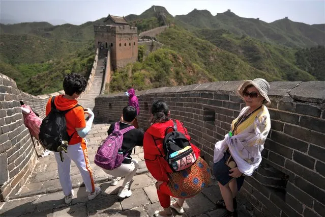 Visitors on a hot day gather along a stretch of the Jinshanling section of the Great Wall of China, north of Beijing in northern China's Hebei Province, Wednesday, July 5, 2023. (Photo by Mark Schiefelbein/AP Photo)