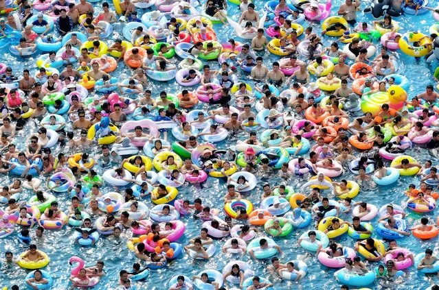 Aerial photo shows people playing at a water park to beat the summer heat in Nanjing City, east China's Jiangsu Province on July 23, 2023. (Photo by Rex Features/Shutterstock)