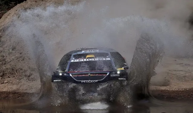 Stephane Peterhansel of France drives his Peugeot through the water during the Buenos Aires-Rosario prologue stage of Dakar Rally 2016 in Arrecifes, Argentina, January 2, 2016. (Photo by Marcos Brindicci/Reuters)