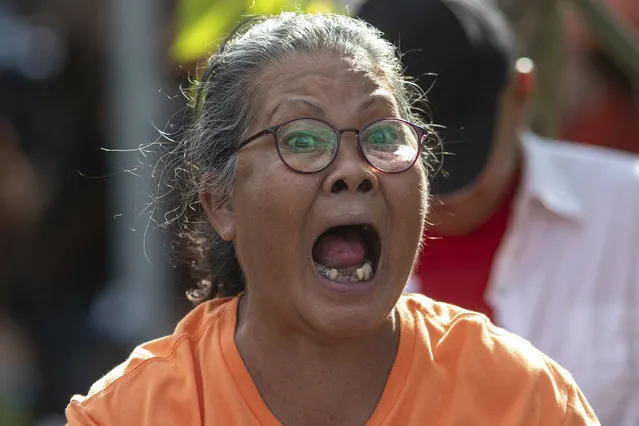 Supporters of Move Forward Party shouting outside parliament during the vote counting at the Parliament in Bangkok, Thailand, Thursday, July 13, 2023. Pita, whose Move Forward Party ran first in Thailand's May 14 general election, was nominated to be prime minister at a joint session of Parliament's Upper and Lower House on Thursday, but failed to attain the majority vote needed to win the job, necessitating a new round of voting expected next week. (Photo by Wason Wanichakorn/AP Photo)
