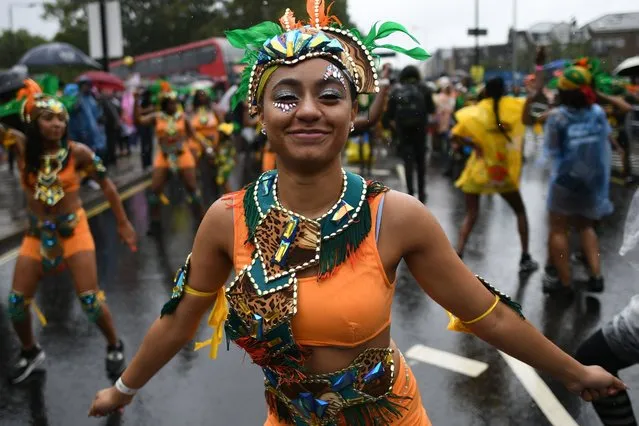 Dancers perform during the Children's Day parade at the Notting Hill Carnival in west London on Sunday, August 26, 2018. (Photo by Stefan Rousseau/PA Wire)