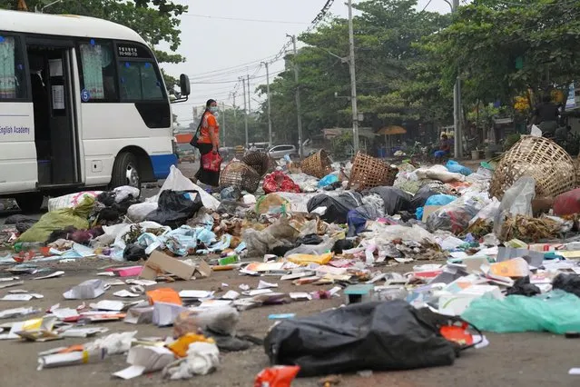 Residents use trash to block streets as a form of protest in Thaketa township, Yangon, Myanmar, in this image obtained by Reuters on March 30, 2021. (Photo by Reuters/Stringer)