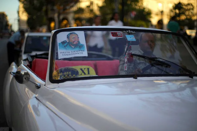 A man drives his car with a poster of Fidel Castro on his windshield in Coliseo, Cuba, November 29, 2016. (Photo by Ivan Alvarado/Reuters)