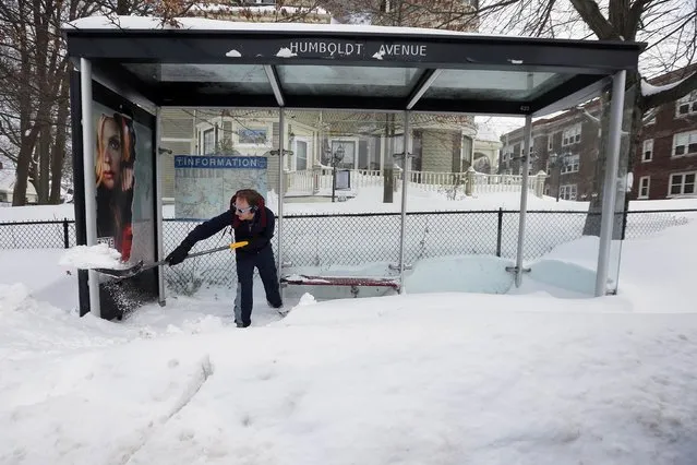 Jake Mongillo, who came out to help clear snow around busy school routes at the request of the activist group Black Lives Matter Boston, shovels out a public bus stop on Humboldt Ave in Boston, Massachusetts February 10, 2015. (Photo by Brian Snyder/Reuters)