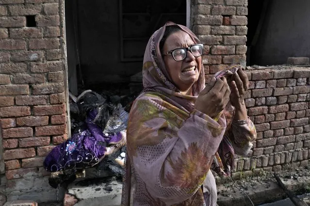 A Christian woman weeps after looking at her home vandalized by an angry Muslim mob in Jaranwala in the Faisalabad district, Pakistan, Thursday, August 17, 2023. Police arrested more than 100 Muslims in overnight raids from an area in eastern Pakistan where a Muslim mob angered over the alleged desecration of the Quran by a Christian man attacked churches and homes of minority Christians, prompting authorities to summon troops to restore order, officials said Thursday. (Photo by K.M. Chaudary/AP Photo)