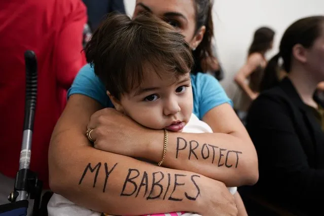 Melissa Alvarez hugs her son, Ignacio, 2, with the words “Protect My Babies” written on her arms in the House Civic Justice Committee of 1st Extraordinary Session meeting during a special session of the state legislature on public safety Wednesday, August 23, 2023, in Nashville, Tenn. Tennessee Republican lawmakers hit an impasse Thursday just a few days into a special session sparked by a deadly school shooting in March, leaving little certainty about what they might ultimately pass, yet all but guaranteeing it won't be any significant gun control change. (Photo by George Walker IV/AP Photo)