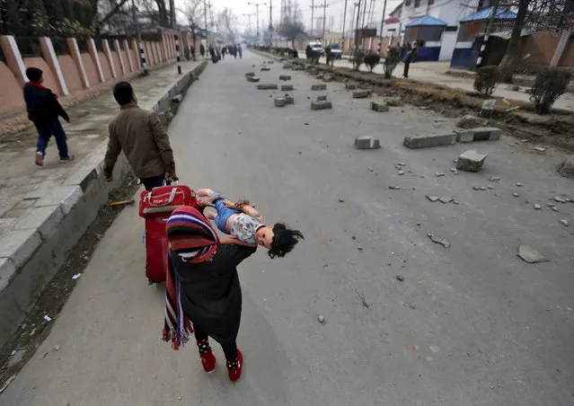 A young tourist carries a doll as she walks on a road during a protest in Srinagar, January 14, 2016. (Photo by Danish Ismail/Reuters)