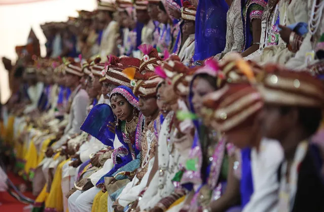 Brides and grooms pose for pictures during a mass wedding ceremony at Ramlila ground in New Delhi June 15, 2014. (Photo by Adnan Abidi/Reuters)