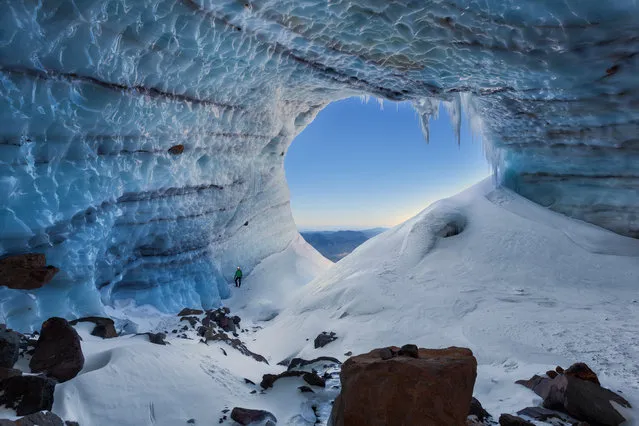 A caver gives scale to the entrance to Snow Dragon Cave. (Photo and caption by Josh Hydeman)