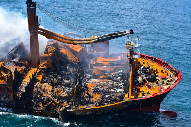Smoke rises from a fire onboard the MV X-Press Pearl vessel as it sinks while being towed into deep sea off the Colombo Harbour, in Sri Lanka on June 2, 2021. The cargo ship, carrying tonnes of chemicals, sank off Sri Lanka's west coast after a fire raged on deck for two weeks, in one of the country's worst-ever marine disasters. (Photo by Sri Lanka Airforce Media/Handout via Reuters)