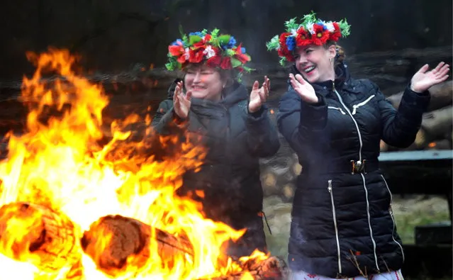 Women wearing floral wreaths during celebrations marking 15 years since Belarusian Father Frost started residing in Belovezhskaya Pushcha, Brest Region, Belarus on December 8, 2018. (Photo by Viktor Drachev/TASS)