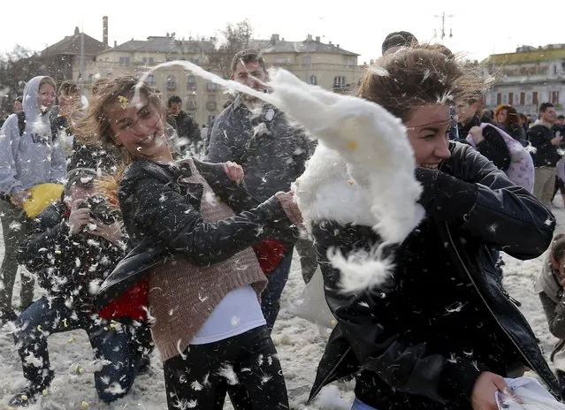 People fight with pillows during International Pillow Fight Day at Heroes Square in Budapest April 4, 2015. (Photo by Laszlo Balogh/Reuters)
