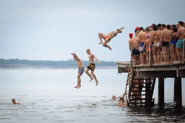 People swim and jump into the water during a traditional New Year's swim in the Adriatic sea in Portoroz, Slovenia on January 1, 2019. (Photo by Jure Makovec/AFP Photo)