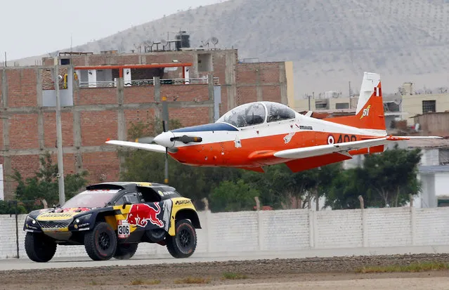 PH Sport's driver Sebastian Loeb races against an airplane during a performance act at the Peru Dakar Rally in Lima, Peru on January 5, 2019. (Photo by Carlos Jasso/Reuters)