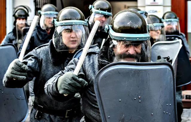 Units of ZOMO (Motorized Reserves of the Citizens' Militia) perform during reenacted street riots – a reconstruction of historical events of 13 December 1981, in Lublin, Poland, 13 December 2013. Martial law in Poland was declared by former general Wojciech Jaruzelski on 13 December 1981 aiming to block reforms urged by the “Solidarity” movement. During a crackdown on political opponents hundreds of people were arrested and some 100 died over an 18-month period. (Photo by Wojciech Pacewicz/EPA)