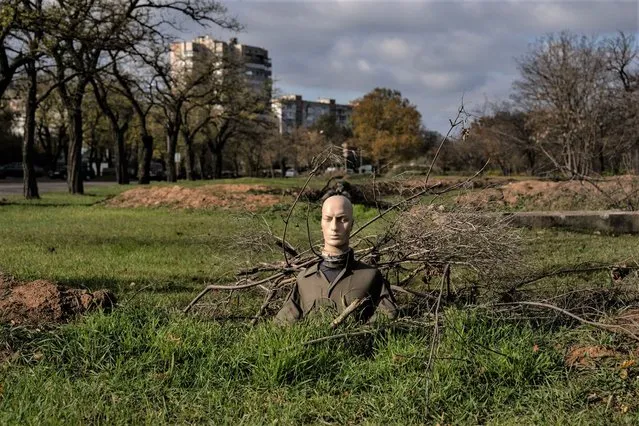 A mannequin dressed in military fatigues is used as a decoy in a trench on October 31, 2022 in Mykolaiv, Mykolaiv oblast, Ukraine. Russia launched another wave of missile strikes across Ukraine today, increasing its attacks on the country's energy infrastructure as winter looms. (Photo by Carl Court/Getty Images)