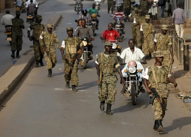 Ugandan soldiers patrol a street in Kampala, Uganda February 20, 2016. (Photo by Goran Tomasevic/Reuters)