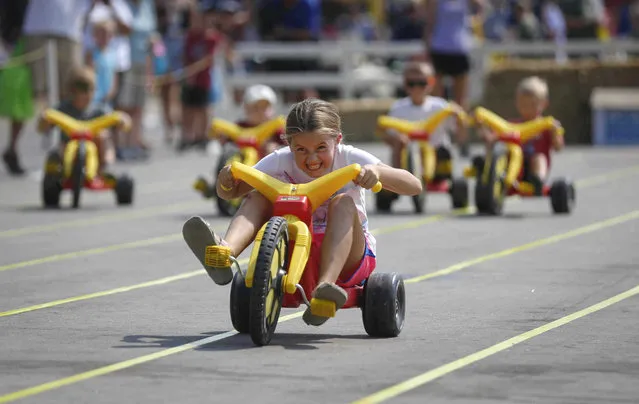 McKenna Cronbaugh, 8, of Raymond, Iowa, won a blue ribbon in the Big Wheel races on the Grand Concourse at the Iowa State Fair on Thursday, August 19, 2021, in Des Moines, Iowa. (Photo by Bryon Houlgrave/The Des Moines Register via AP Photo)