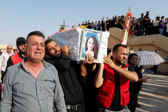 Mourners carry a coffin of a victim of the fatal fire of a wedding celebration, during the funeral in Hamdaniya, Iraq on September 27, 2023. (Photo by Khalid Al-Mousily/Reuters)