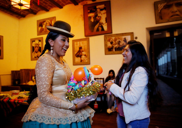 A Cholita (Andean woman) model receives a present after a practice session at the Rosario Aguilar fashion model school in La Paz, Bolivia, February 23, 2019. (Photo by David Mercado/Reuters)