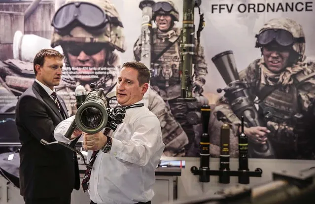 An exhibitor of SAAB, a Swedish defense company, shows the 85MM Carl-Gustaf, a portable artillery system during the 8th International Land and Naval Defense system exhibition, in New Delhi, India, on February 6, 2014. (Photo by Manish Swarup/Associated Press)