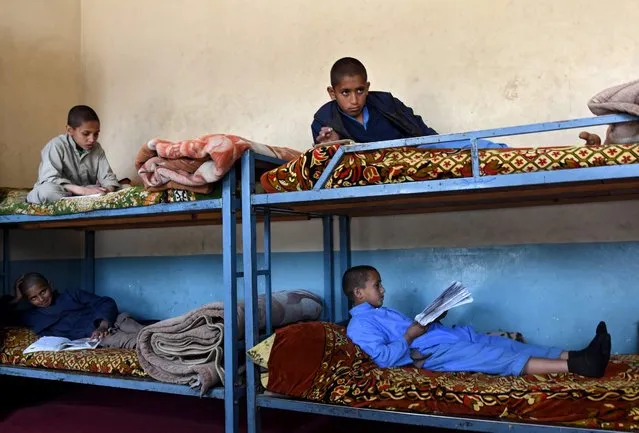 Afghan orphaned children whose parents during the war in Afghanistan, read books at a school hostel room, in Jalalabad, Afghanistan, 25 February 2016. The United Nations says more than 11,000 civilians were killed or wounded in violence in Afghanistan in 2015, making it the worst year for civilian casualties since the organization began compiling the statistics in 2009. (Photo by Ghulamullah Habibi/EPA)