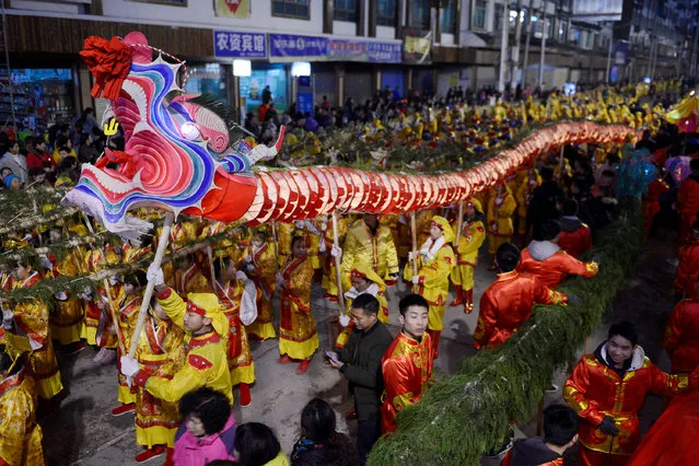 People hold a dragon lantern as they parade to celebrate the Chinese Lunar New Year, in Qiandongnan Miao and Dong autonomous prefecture, Guizhou province, China February 1, 2017. (Photo by Reuters/Stringer)