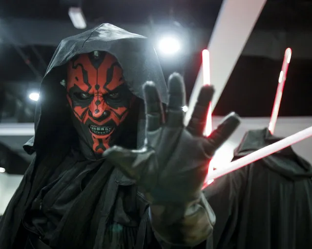 A Star Wars fan dressed as Darth Maul poses for photograph at a Star Wars Day gathering in a mall downtown Kuala Lumpur, Malaysia, Saturday, May 2, 2015. (Photo by Joshua Paul/AP Photo)