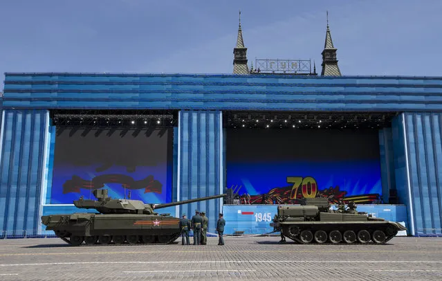 Russian army officers speak a crew member of new a Russian T-14 Armata tank at the Red Square during a preparation for general rehearsal for the Victory Day military parade which will take place at Moscow's Red Square on May 9 to celebrate 70 years after the victory in WWII, in Moscow, Russia, Thursday, May 7, 2015. (Photo by Alexander Zemlianichenko/AP Photo)