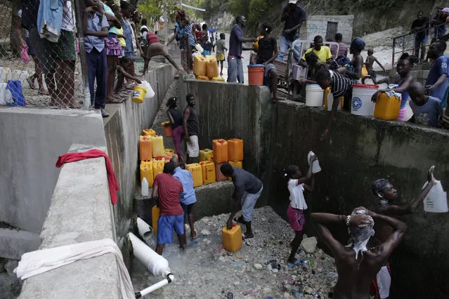 Haitians fill containers with water as others take a bath with water from a pipe in Port-au-Prince, Haiti, March 3, 2016. March 22 marks World Water Day. (Photo by Andres Martinez Casares/Reuters)