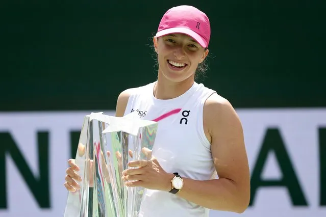 Iga Swiatek of Poland poses for photographers after defeating Maria Sakkari of Greece during the Women's Final of the BNP Paribas Open at Indian Wells Tennis Garden on March 17, 2024 in Indian Wells, California. (Photo by Matthew Stockman/Getty Images)