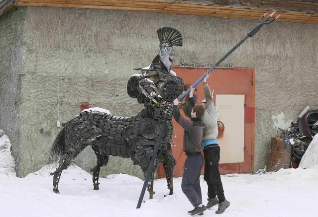 Mechanic and welder Sergei Kulagin (R) and his assistant prepare to transport the “Centaurus” sculpture, made of used car components, outside an automobile repair workshop in the Siberian town of Divnogorsk, Russia, February 20, 2017. Enthusiast Kulagin, who works as a mechanic of an automobile service station, creates sculptures made of used car parts and components during his non-working hours. (Photo by Ilya Naymushin/Reuters)
