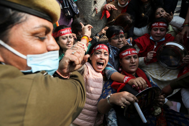 A police officer tries to detain the supporters of the women's wing of India's main opposition Congress Party during a protest against what they say is rising inflation in the country, in New Delhi, India, November 30, 2021. (Photo by Anushree Fadnavis/Reuters)