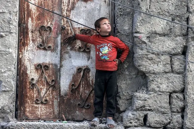 A Palestinian boy looks at a drone in the sky in the southern Gaza Strip city of Rafah on April 2, 2024, amid the ongoing conflict between Israel and Hamas. (Photo by Mohammed Abed/AFP Photo)