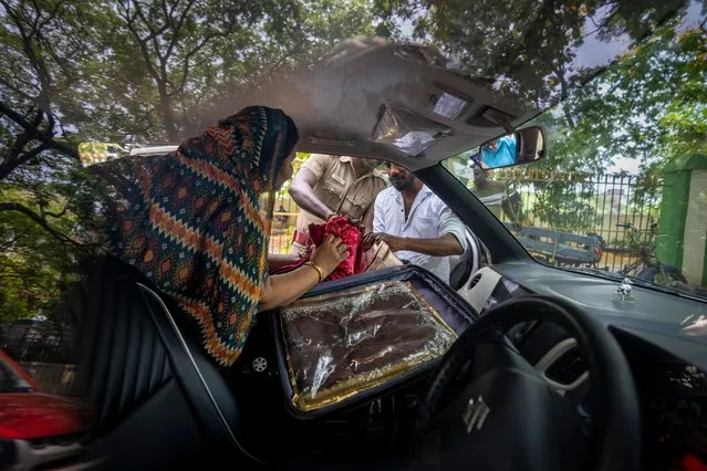 Indian police officers check the suitcase of a woman as they search vehicles for any prohibited items ahead of country's general elections, in the southern Indian city of Chennai, Wednesday, April 17, 2024. (Photo by Altaf Qadri/AP Photo)