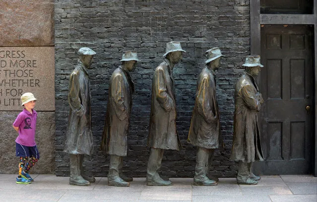 Ulysses Watko, 7, visiting from Portland, OR, plays amid The Breadline sculpture at the Franklin Delano Roosevelt Memorial in Washington, U.S., August 7, 2019. (Photo by Mary F. Calvert/Reuters)