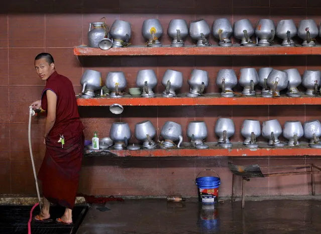 A Tibetan monk washes his feet in a community kitchen during celebrations to mark the 80th birthday of the Tibetan spiritual leader, the Dalai Lama, at the Sera Jey Monastery in Bylakuppe in Karnataka, India, July 6, 2015. (Photo by Abhishek N. Chinnappa/Reuters)