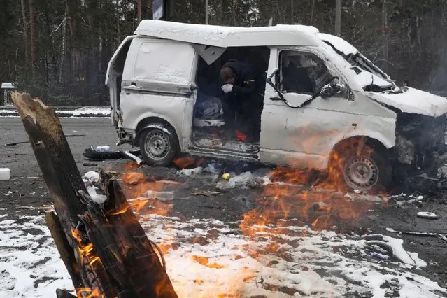 A man reacts inside a vehicle damaged by shelling, in Brovary, outside Kyiv, Ukraine, Tuesday, March 1, 2022. Russian shelling pounded civilian targets in Ukraine's second-largest city again Tuesday and a 40-mile convoy of tanks and other vehicles threatened the capital – tactics Ukraine's embattled president said were designed to force him into concessions in Europe's largest ground war in generations. (Photo by Efrem Lukatsky/AP Photo)