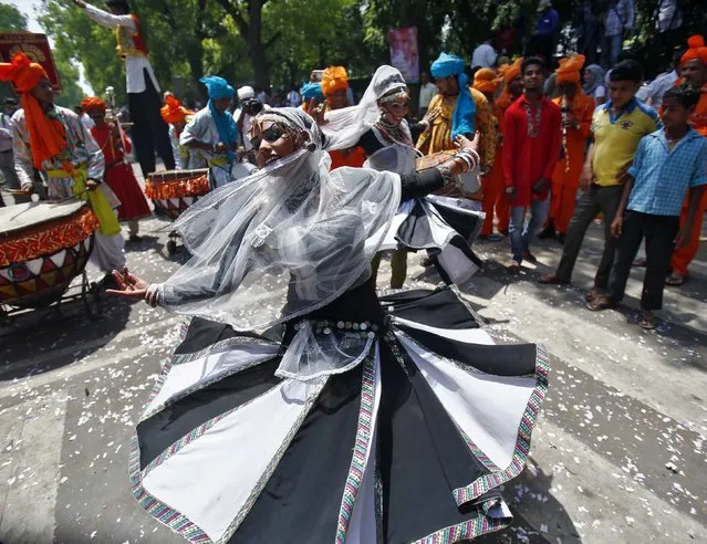 A supporter of BJP dances during celebrations after learning of initial poll results outside the party headquarters in New Delhi, on May 16, 2014. (Photo by Anindito Mukherjee/Reuters)