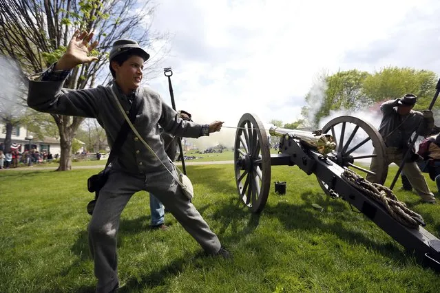 A man portraying a Civil War soldier from the South fires a cannon during Civil War Days at Naper Settlement in Naperville, Illinois, May 17, 2014. Participants dress in period costumes to recreate a battle scene from the war that took place in the United States from 1861-1865.. (Photo by Jim Young/Reuters)