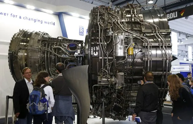 Visitors look at a Rolls-Royce Trent XWB aircraft engine at the company's booth during the ILA Berlin Air Show in Schoenefeld, south of Berlin, Germany, June 1, 2016. (Photo by Fabrizio Bensch/Reuters)
