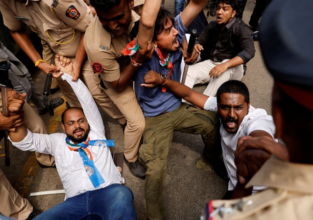 Congress party supporters are restrained during a protest, demanding a probe against SEBI chief Madhabi Puri Buch and her husband Dhaval Buch and the Adani group after their names were mentioned in the Hindenburg research in its latest report, on a street in Mumbai, India on August 22, 2024. (Photo by Francis Mascarenhas/Reuters)