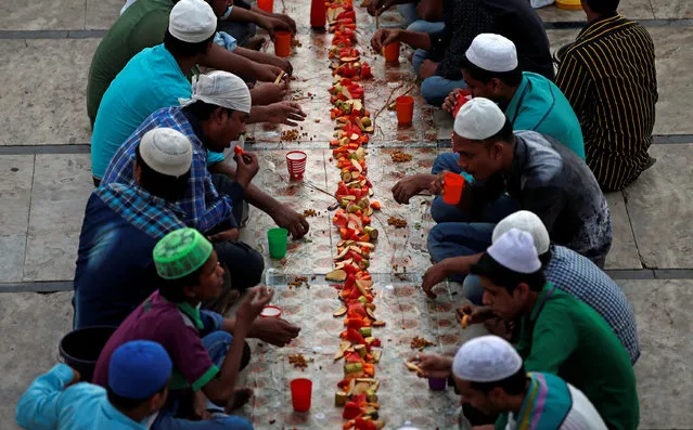 People eat their Iftar (breaking fast) meals inside a mosque during the holy month of Ramadan, in Ahmedabad, India June 1, 2017. (Photo by Amit Dave/Reuters)