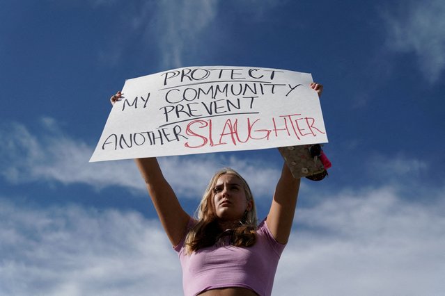 Student Gretchen Gierlach, 18, holds up a sign following a shooting at Apalachee High School in Winder, Georgia on September 4, 2024. (Photo by Elijah Nouvelage/Reuters)