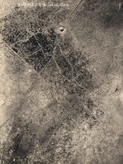 An aerial photograph taken from a British aeroplane shows a view of trenches with a giant crater and shell damage marking the land between the trenches on the Western Front, in this September 7, 1916 handout picture. This picture is part of a previously unpublished set of World War One (WWI) images from a private collection. The pictures offer an unusual view of varied and contrasting aspects of the conflict, from high tech artillery to mobile pigeon lofts, and from officers partying in their headquarters to the grim reality of life and death in the trenches. The year 2014 marks the centenary of the start of the war. (Photo by Reuters/Archive of Modern Conflict London)