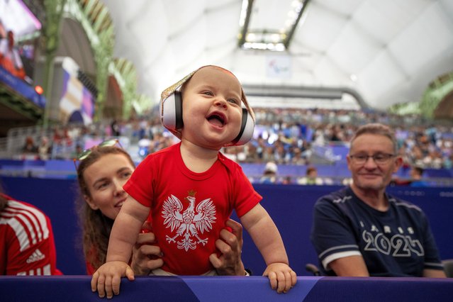 Marcelina, 10 months old, for Poland, reacts watching a Wheelchair Fencing Women's Sabre Cat. A competition, at the 2024 Paralympics, Tuesday, September 3, 2024, in Paris, France. (Photo by Emilio Morenatti/AP Photo)